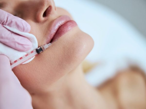 Certified doctor performing the lip augmentation procedure